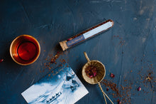 Load image into Gallery viewer, Test Tube of The Tea Nomad&#39;s Sahara tea- a caffeine- free blend of organic rooibos, crushed vanilla and red rose petals